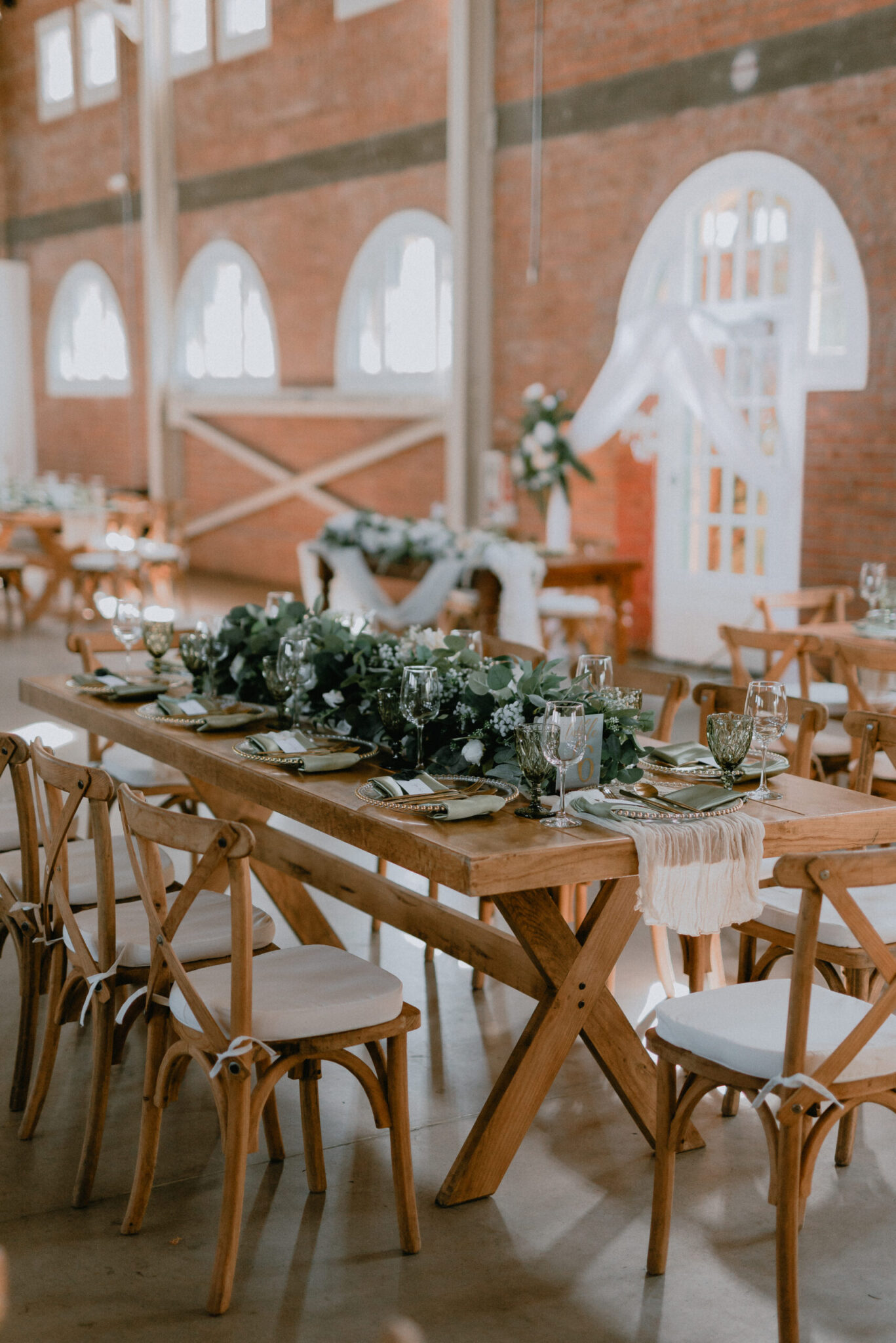 Rustic event rentals in San Diego with farm tables and crossback chairs